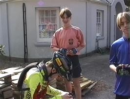 Julian makes adjustments to Matthew's helmet so it will be safer for him on the ride